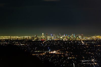 Aerial shot of glowing lights of Melbourne City and suburban sprawl at night