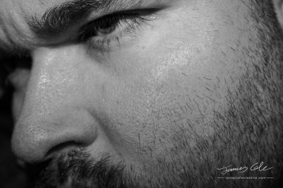 Intense close up mans face brooding black and white