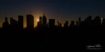 Melbourne city skyline silhouetted by a dramatic sunset
