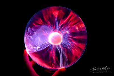 JCCI-100073 - Hand holding plasma ball blue violet purple and red