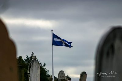 JCCI-100096 - Eureka flag flying in the wind on a gloomy overcast day in the old Ballarat cemetery