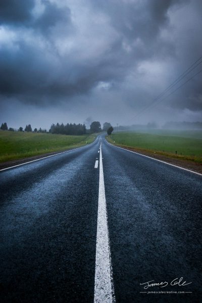 JCCI-100125 - A lonely country road shrouded in mysterious moody clouds and mist