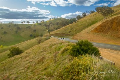 JCCI-100623 - Winding country road through a dry grassy hillside vista